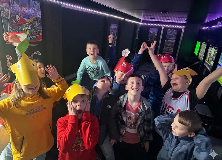 Kids having a blast at a GameTruck video game birthday party