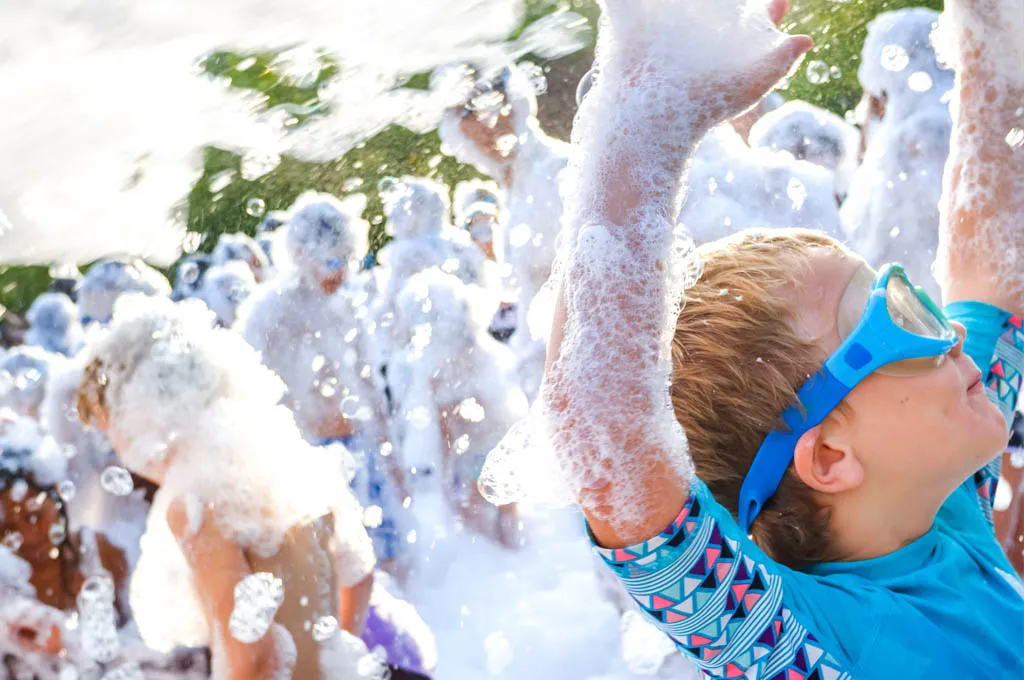 Kids playing in mountains of foam at GameTruck foam party